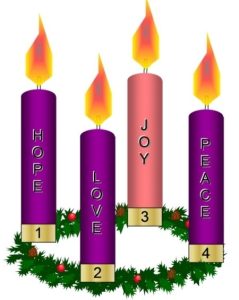 Four Advent candles on a green wreathe